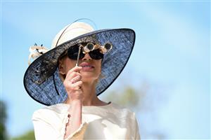 ASCOT, ENGLAND - JUNE 16: A racegoer looking through binoculars during Royal Ascot 2022 at Ascot Racecourse on June 16, 2022 in Ascot, England. (Photo by Eamonn M. McCormack/Getty Images for Ascot Racecourse)
