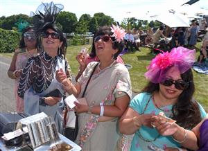 ASCOT, ENGLAND - JUNE 16: Racegoers wearing sarees place bets during Royal Ascot 2022 at Ascot Racecourse on June 16, 2022 in Ascot, England. (Photo by Eamonn M. McCormack/Getty Images for Ascot Racecourse)