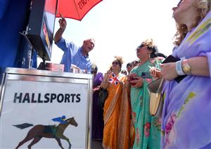 ASCOT, ENGLAND - JUNE 16: Racegoers wearing sarees place bets during Royal Ascot 2022 at Ascot Racecourse on June 16, 2022 in Ascot, England. (Photo by Eamonn M. McCormack/Getty Images for Ascot Racecourse)