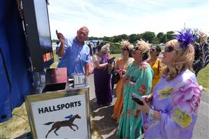 ASCOT, ENGLAND - JUNE 16: Racegoers wearing sarees place bets during Royal Ascot 2022 at Ascot Racecourse on June 16, 2022 in Ascot, England. (Photo by Eamonn M. McCormack/Getty Images for Ascot Racecourse)