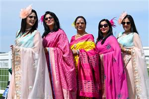 ASCOT, ENGLAND - JUNE 16: Racegoers wearing sarees pose for photographs during Royal Ascot 2022 at Ascot Racecourse on June 16, 2022 in Ascot, England. (Photo by Eamonn M. McCormack/Getty Images for Ascot Racecourse)