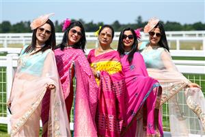 ASCOT, ENGLAND - JUNE 16: Racegoers wearing sarees pose for photographs during Royal Ascot 2022 at Ascot Racecourse on June 16, 2022 in Ascot, England. (Photo by Eamonn M. McCormack/Getty Images for Ascot Racecourse)