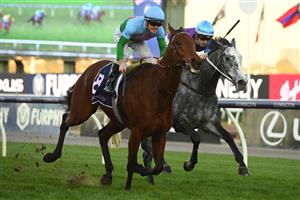 MELBOURNE, AUSTRALIA - JUNE 18: Jarrod Fry riding Tuvalu winning Race 8, the The David Bourke, during Melbourne Racing at Flemington Racecourse on June 18, 2022 in Melbourne, Australia. (Photo by Vince Caligiuri/Getty Images)
