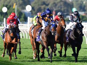MELBOURNE, AUSTRALIA - JUNE 18: Michael Dee riding Biometric (r) winning Race 6, the Brian Beattie Handicap, during Melbourne Racing at Flemington Racecourse on June 18, 2022 in Melbourne, Australia. (Photo by Vince Caligiuri/Getty Images)