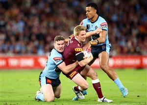 BRISBANE, AUSTRALIA - JULY 13: Tom Dearden of the Maroons is tackled during game three of the State of Origin Series between the Queensland Maroons and the New South Wales Blues at Suncorp Stadium on July 13, 2022, in Brisbane, Australia. (Photo by Chris Hyde/Getty Images)