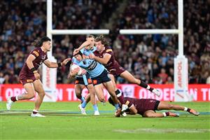 BRISBANE, AUSTRALIA - JULY 13: Matt Burton of the Blues is tackled by Patrick Carrigan of the Maroons during game three of the State of Origin Series between the Queensland Maroons and the New South Wales Blues at Suncorp Stadium on July 13, 2022 in Brisbane, Australia. (Photo by Bradley Kanaris/Getty Images)