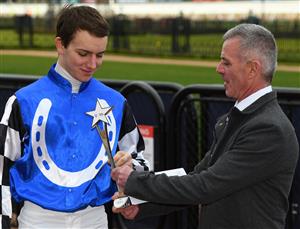 MELBOURNE, AUSTRALIA - JULY 16: Darren Gauci presents Matthew Cartwright the trophy after winning the Apprentices Only Rising Stars series during Melbourne Racing at Flemington Racecourse on July 16, 2022 in Melbourne, Australia. (Photo by Vince Caligiuri/Getty Images)