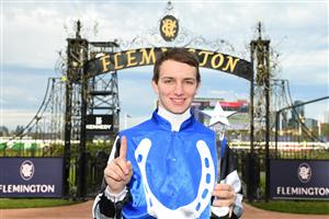 MELBOURNE, AUSTRALIA - JULY 16: Matthew Cartwright poses after winning the Apprentices Only Rising Stars series trophy during Melbourne Racing at Flemington Racecourse on July 16, 2022 in Melbourne, Australia. (Photo by Vince Caligiuri/Getty Images)