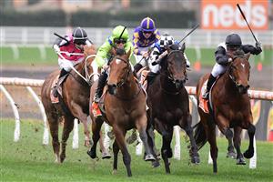 MELBOURNE, AUSTRALIA - JULY 23: Will Price riding Thron Bone winning Race 1, the Mrc Membership Renewal Handicap, during Melbourne Racing at Caulfield Racecourse on July 23, 2022 in Melbourne, Australia. (Photo by Vince Caligiuri/Getty Images)