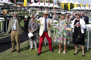 CHICHESTER, ENGLAND - JULY 28: Racegoers watch the big screen during day three of the Qatar Goodwood Festival at Goodwood Racecourse on July 28, 2022 in Chichester, England. (Photo by Alan Crowhurst/Getty Images)