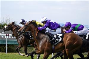 CHICHESTER, ENGLAND - JULY 28: Hollie Doyle riding Prairie Falcon (L, white/blue) win The Jaeger-Lecoultre Nursery during day three of the Qatar Goodwood Festival at Goodwood Racecourse on July 28, 2022 in Chichester, England. (Photo by Alan Crowhurst/Getty Images)