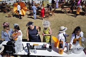 CHICHESTER, ENGLAND - JULY 29: Buying Champagne during day four of the Qatar Goodwood Festival at Goodwood Racecourse on July 29, 2022 in Chichester, England. (Photo by Alan Crowhurst/Getty Images)