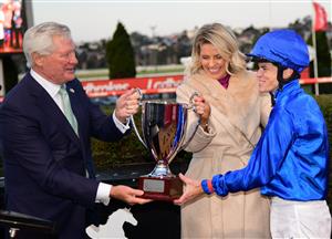 MELBOURNE, AUSTRALIA - JULY 30: Chairman, Don Casboult presents the trophy to Craig Williams after riding Lackeen in Race 8, the Ranvet Travis Harrison Cup, during Melbourne Racing at Moonee Valley Racecourse on July 30, 2022 in Melbourne, Australia. (Photo by Vince Caligiuri/Getty Images)