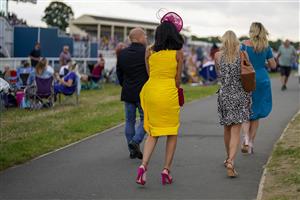 YORK, ENGLAND - AUGUST 18: Racegoers in the Clock Tower Enclosure at York Racecourse on August 18, 2022 in York, England. (Photo by Alan Crowhurst/Getty Images)