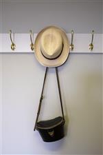 YORK, ENGLAND - AUGUST 20: Panama hat and binocular case hang in the press room at York Racecourse on August 20, 2022 in York, England. (Photo by Alan Crowhurst/Getty Images)