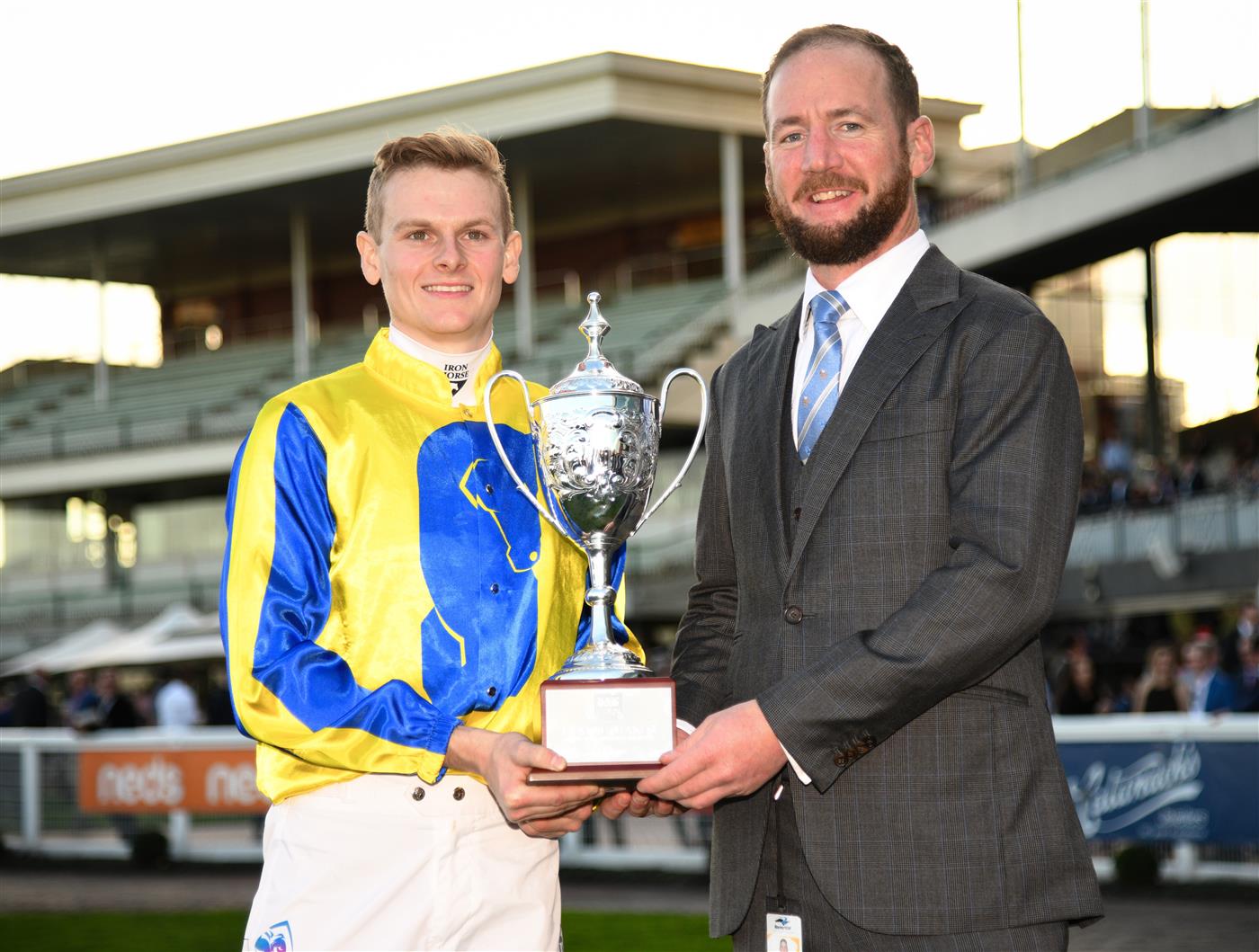 MELBOURNE, AUSTRALIA - AUGUST 27: Ethan Brown and trainer Ciaron Maher pose with trophy after Snapdancer won Race 8, the Magic Millions Memsie Stakes,  during Melbourne Racing at Caulfield Racecourse on August 27, 2022 in Melbourne, Australia. (Photo by Vince Caligiuri/Getty Images)