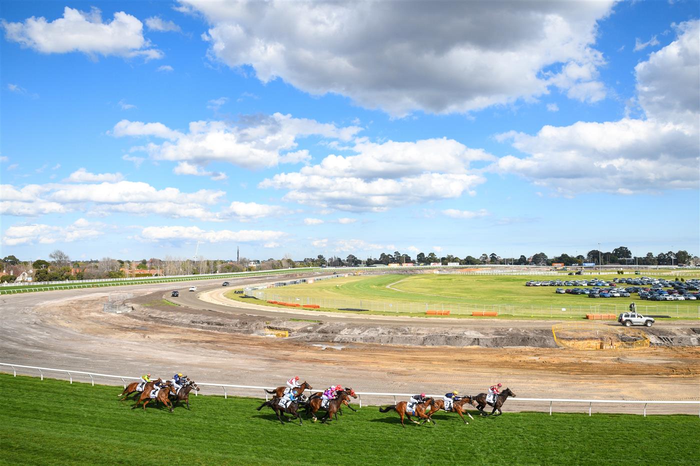 MELBOURNE, AUSTRALIA - AUGUST 27: Jamie Kah riding I Wish I Win (#14) midfield turning for home before winning Race 4, the Ive Handicap,  during Melbourne Racing at Caulfield Racecourse on August 27, 2022 in Melbourne, Australia. (Photo by Vince Caligiuri/Getty Images)