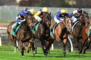 MELBOURNE, AUSTRALIA - AUGUST 27: Blake Shinn riding Munhamek (L) winning Race 3, the Evergreen Turf Handicap, during Melbourne Racing at Caulfield Racecourse on August 27, 2022 in Melbourne, Australia. (Photo by Vince Caligiuri/Getty Images)