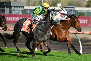 MELBOURNE, AUSTRALIA - AUGUST 27: Jamie Kah riding Chain Of Lightning winning Race 7, the W.w. Cockram Stakes, during Melbourne Racing at Caulfield Racecourse on August 27, 2022 in Melbourne, Australia. (Photo by Vince Caligiuri/Getty Images)