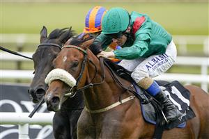 KILDARE, IRELAND - SEPTEMBER 11: Chris Hayes riding Tahiyra (green) win The Moyglare Stud Stakes at Curragh Racecourse on September 11, 2022 in Kildare, Ireland. (Photo by Alan Crowhurst/Getty Images)