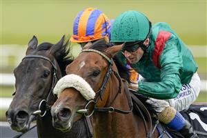 KILDARE, IRELAND - SEPTEMBER 11: Chris Hayes riding Tahiyra (green) win The Moyglare Stud Stakes at Curragh Racecourse on September 11, 2022 in Kildare, Ireland. (Photo by Alan Crowhurst/Getty Images)