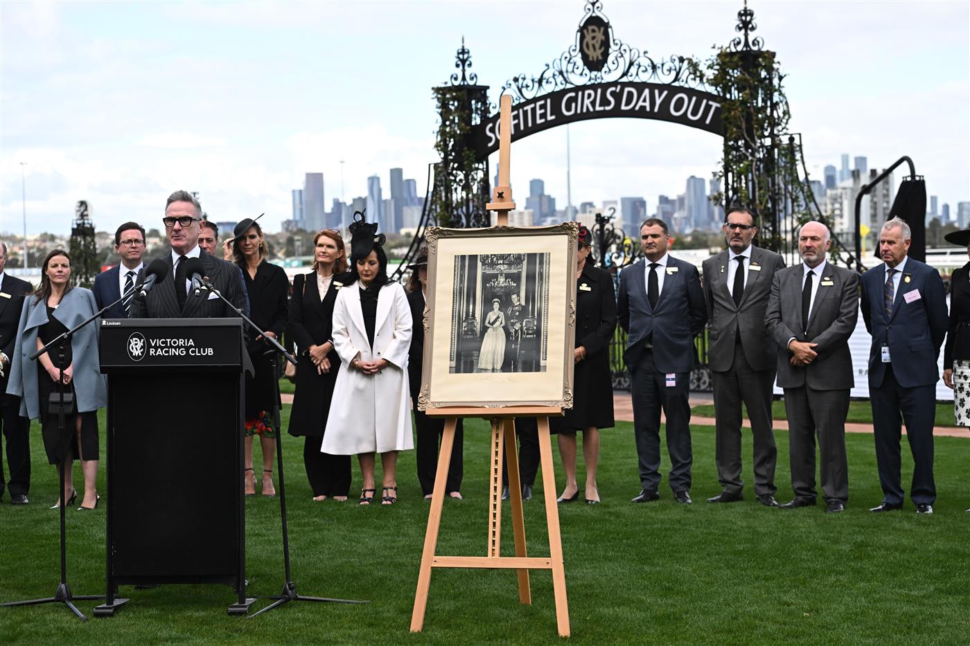 MELBOURNE, AUSTRALIA - SEPTEMBER 10: VRC Chairman, Neil Wilson, Jockeys and officials observe a minutes silence in memory of Her Majesty Queen Elizabeth II during Melbourne Racing at Flemington Racecourse on September 10, 2022 in Melbourne, Australia. (Photo by Vince Caligiuri/Getty Images)