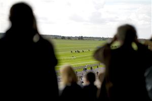 NEWMARKET, ENGLAND - SEPTEMBER 23: A general view as racegoers look on as runners near the finish during The Princess Royal Al Basti Equiworld, Dubai Stakes at Newmarket Racecourse on September 23, 2022 in Newmarket, England. (Photo by Alan Crowhurst/Getty Images)