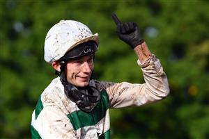 British jockey Luke Morris celebrates while riding on "Alpinista" after winning in The Prix de l