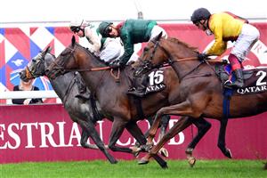 British jockey Luke Morris (L) riding on "Alpinista" crosses the finish line to win The Prix de l
