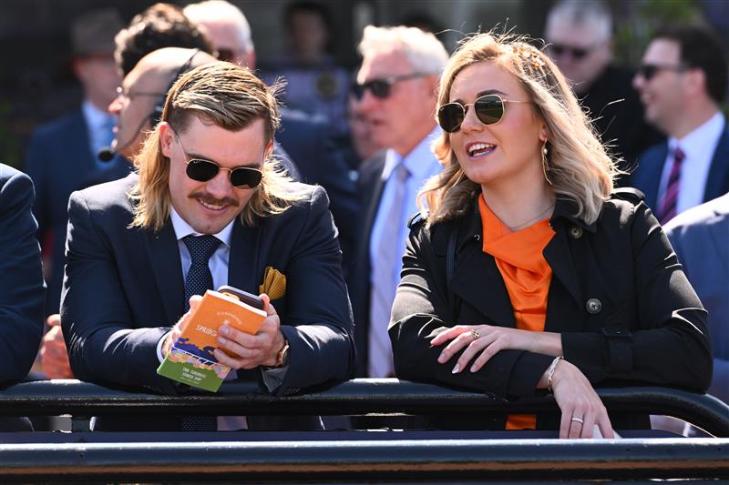MELBOURNE, AUSTRALIA - OCTOBER 01: Australian swimmer, Ariarne Titmus and Kyle Niesler are seen during Turnbull Stakes Day at Flemington Racecourse on October 01, 2022 in Melbourne, Australia. (Photo by Vince Caligiuri/Getty Images)