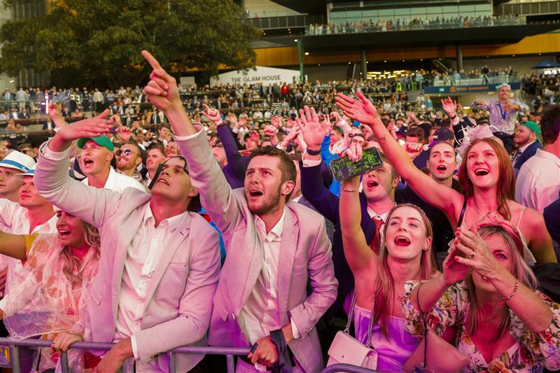 SYDNEY, AUSTRALIA - OCTOBER 01: Racegoers dance to a Queen cover band after the last race during Sydney Racing at Royal Randwick Racecourse on October 01, 2022 in Sydney, Australia. (Photo by Jenny Evans/Getty Images)