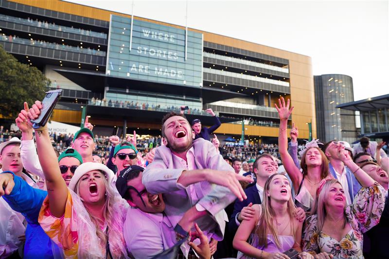 SYDNEY, AUSTRALIA - OCTOBER 01: Racegoers dance to a Queen cover band after the last race during Sydney Racing at Royal Randwick Racecourse on October 01, 2022 in Sydney, Australia. (Photo by Jenny Evans/Getty Images)