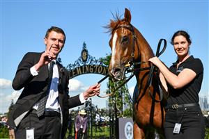 MELBOURNE, AUSTRALIA - OCTOBER 01: Trainer Clayton Douglas poses with Giga Kick after winning Race 5, the Hq Tavern Danehill Stakes, during Turnbull Stakes Day at Flemington Racecourse on October 01, 2022 in Melbourne, Australia. (Photo by Vince Caligiuri/Getty Images)