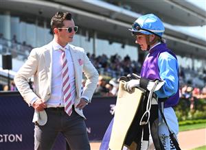 MELBOURNE, AUSTRALIA - OCTOBER 01: Trainer Michael Kent Jnr speaks to Jamie Kah after she rode Visinari to win Race 2, the Katherine Bourke Paris Lane Stakes, during Turnbull Stakes Day at Flemington Racecourse on October 01, 2022 in Melbourne, Australia. (Photo by Vince Caligiuri/Getty Images)
