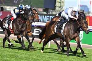 MELBOURNE, AUSTRALIA - OCTOBER 01: Michael Dee riding Lunar Flare winning Race 6, the The Lexus Bart Cummings, during Turnbull Stakes Day at Flemington Racecourse on October 01, 2022 in Melbourne, Australia. (Photo by Vince Caligiuri/Getty Images)