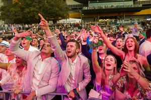 SYDNEY, AUSTRALIA - OCTOBER 01: Racegoers dance to a Queen cover band after the last race during Sydney Racing at Royal Randwick Racecourse on October 01, 2022 in Sydney, Australia. (Photo by Jenny Evans/Getty Images)
