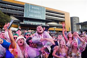 SYDNEY, AUSTRALIA - OCTOBER 01: Racegoers dance to a Queen cover band after the last race during Sydney Racing at Royal Randwick Racecourse on October 01, 2022 in Sydney, Australia. (Photo by Jenny Evans/Getty Images)