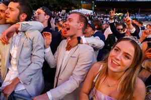 SYDNEY, AUSTRALIA - OCTOBER 01: Racegoers dance to a Queen cover band after the last race during Sydney Racing at Royal Randwick Racecourse on October 01, 2022 in Sydney, Australia. (Photo by Jenny Evans/Getty Images)