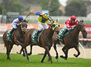 MELBOURNE, AUSTRALIA - OCTOBER 12: Ethan Brown riding Port Phillip (r) defeats Damien Oliver riding Kissinger in Race 2, the Evergreen Turf Handicap, during Caulfield Thousand Guineas Day at Caulfield Racecourse on October 12, 2022 in Melbourne, Australia. (Photo by Vince Caligiuri/Getty Images)