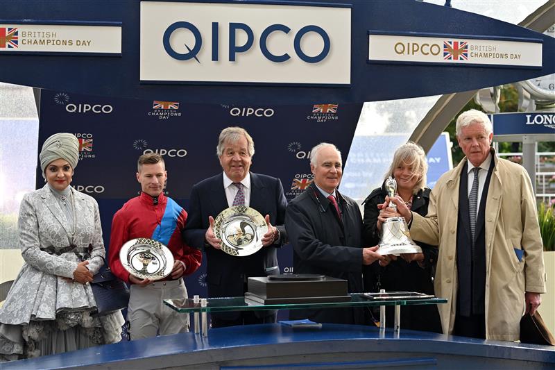 Sheikha Amna bint Abdulaziz Al Thani (L), British jockey Richard Kingscote (2nd L), trainer Michael Stoute (C), connections of Ballylinch Stud and owner James Wigan (R) pose at the presentation for the Champion Stakes on Qipco British Champions Day at Ascot Racecourse, west of London on October 15, 2022. - Champions day is the finale of the British flat racing season and the UK's richest raceday. (Photo by Glyn KIRK / AFP) (Photo by GLYN KIRK/AFP via Getty Images)
