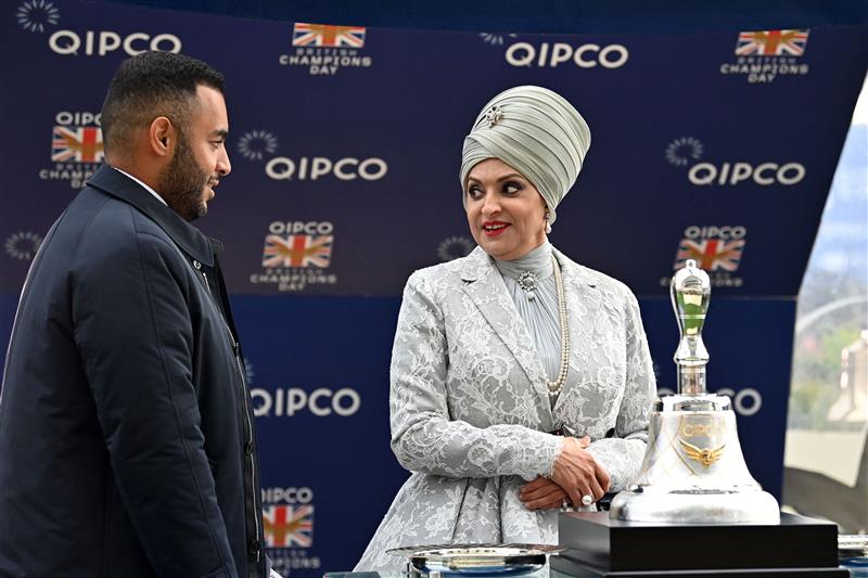 Sheikh Fahad Al-Thani (L) speaks with Sheikha Amna bint Abdulaziz Al Thani as they wait at the presentation for the Champion Stakes on Qipco British Champions Day at Ascot Racecourse, west of London on October 15, 2022. - Champions day is the finale of the British flat racing season and the UK's richest raceday. (Photo by Glyn KIRK / AFP) (Photo by GLYN KIRK/AFP via Getty Images)