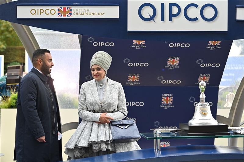 Sheikh Fahad Al-Thani (L) speaks with Sheikha Amna bint Abdulaziz Al Thani as they wait at the presentation for the Champion Stakes on Qipco British Champions Day at Ascot Racecourse, west of London on October 15, 2022. - Champions day is the finale of the British flat racing season and the UK's richest raceday. (Photo by Glyn KIRK / AFP) (Photo by GLYN KIRK/AFP via Getty Images)