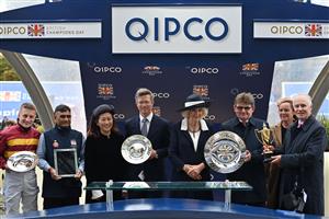 Britain's Camilla, Queen Consort (C) poses for a photograph with connections of Bayside Boy, the winner of the Queen Elizabeth II Stakes on Qipco British Champions Day at Ascot Racecourse, west of London on October 15, 2022. - Champions day is the finale of the British flat racing season and the UK's richest raceday. (Photo by Glyn KIRK / AFP) (Photo by GLYN KIRK/AFP via Getty Images)
