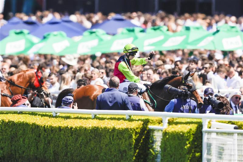 SYDNEY, AUSTRALIA - OCTOBER 15: Robbie Dolan (lime cap) on Cisco Bay returns to scale after winning race 2 the Big Dance Wild Card during Everest Day at Royal Randwick Racecourse on October 15, 2022 in Sydney, Australia. (Photo by Jenny Evans/Getty Images)