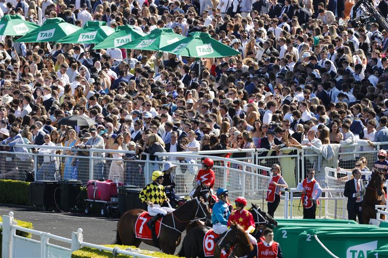 SYDNEY, AUSTRALIA - OCTOBER 15: A general view of crowd as horses and jockeys make their way onto the track for race 6 the Fujitsu General Sydney Stakes during Everest Day at Royal Randwick Racecourse on October 15, 2022 in Sydney, Australia. (Photo by Jenny Evans/Getty Images)
