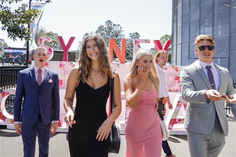 SYDNEY, AUSTRALIA - OCTOBER 15: Race-goers pose for photos at a Sydney Spring Racing display during Everest Day at Royal Randwick Racecourse on October 15, 2022 in Sydney, Australia. (Photo by Jenny Evans/Getty Images)
