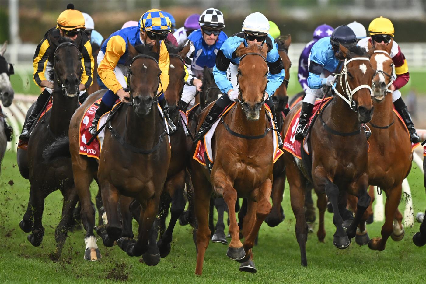 MELBOURNE, AUSTRALIA - OCTOBER 15: Tim Clark riding Knights Order  crosses in front of Jamie Kah riding Smokin