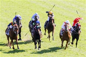 SYDNEY, AUSTRALIA - OCTOBER 15: Craig Williams (red and white) on Giga Kick wins race 7 The Tab Everest during Everest Day at Royal Randwick Racecourse on October 15, 2022 in Sydney, Australia. (Photo by Jenny Evans/Getty Images)