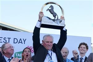 Rod Douglas, racing manager of the winner horse Giga Kick, lifts the Everest 2022 horse race trophy at the Royal Randwick race course in Sydney on October 15, 2022. - XGTY-- IMAGE RESTRICTED TO EDITORIAL USE - STRICTLY NO COMMERCIAL USE -- (Photo by DAVID GRAY / AFP) / XGTY-- IMAGE RESTRICTED TO EDITORIAL USE - STRICTLY NO COMMERCIAL USE -- (Photo by DAVID GRAY/AFP via Getty Images)