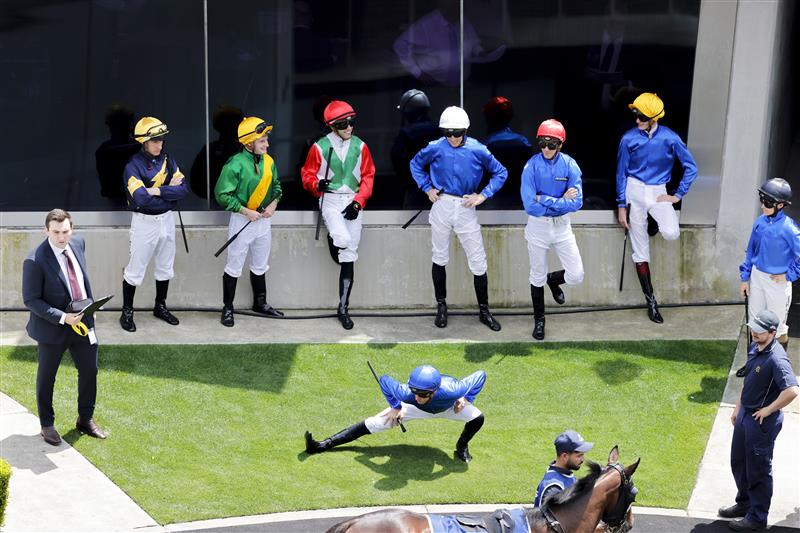 SYDNEY, AUSTRALIA - OCTOBER 22: Jockeys stretch and wait to mount up ahead of race 2 during Spring Champions Stakes Day at Royal Randwick Racecourse on October 22, 2022 in Sydney, Australia. (Photo by Jenny Evans/Getty Images)